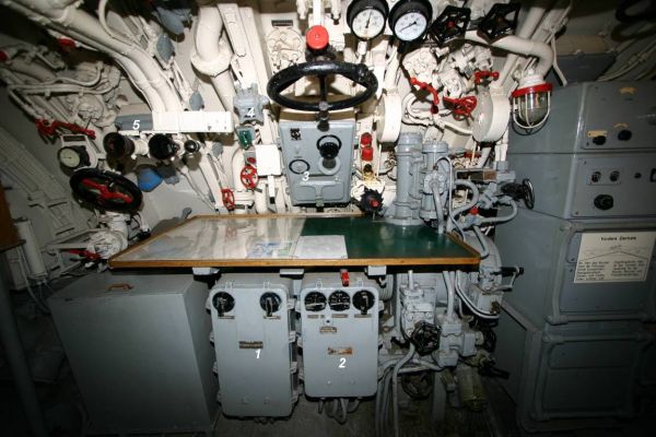 The components of the torpedo fire control system in U 995’s control room – visible are the control boxes of the aiming and torpedo firing subsystems, the main distribution box, target follow-up switch and timing control box